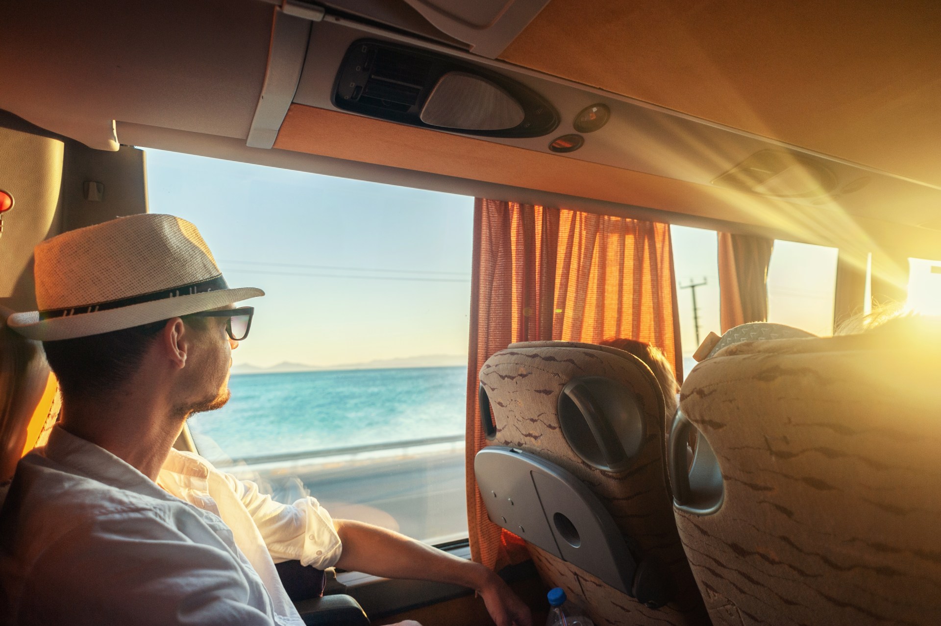 Man traveling in bus looking to the sea